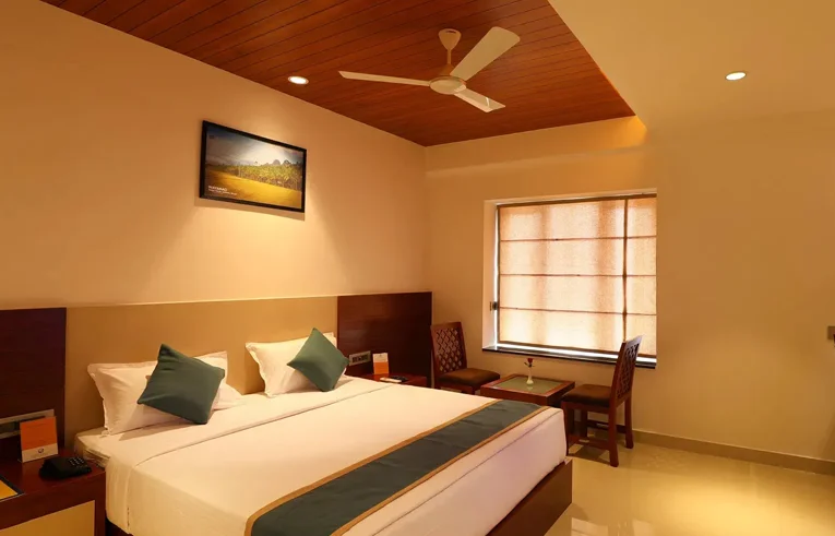 Comfortable bed with pocketed spring mattress in Bliss Room - Best Place To Stay In Wayanad