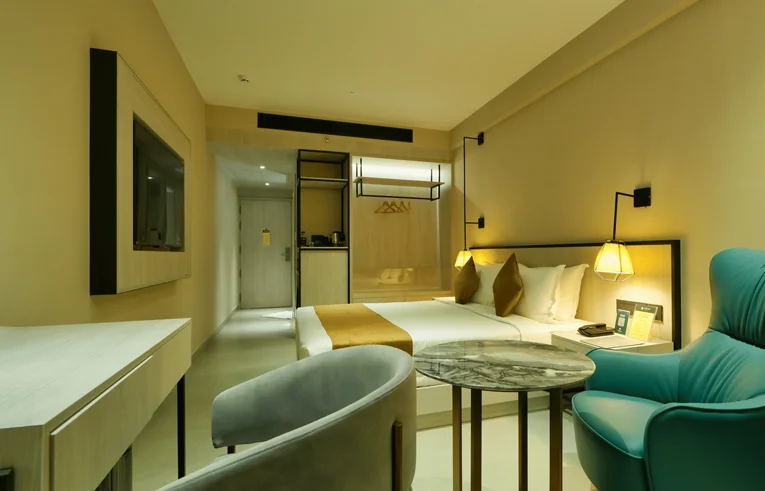 King size bed with 10-inch pocketed spring mattress in Pride Room - Premium accommodation in Wayanad